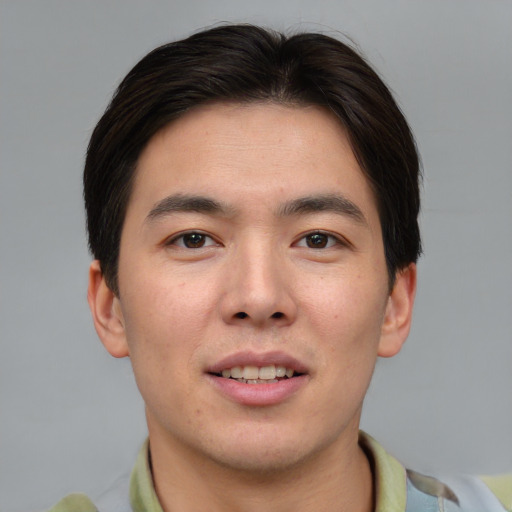 Joyful asian young-adult male with short  brown hair and brown eyes
