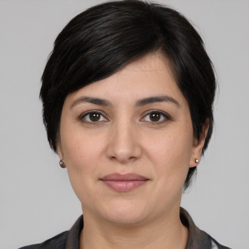 Joyful white young-adult female with medium  black hair and brown eyes