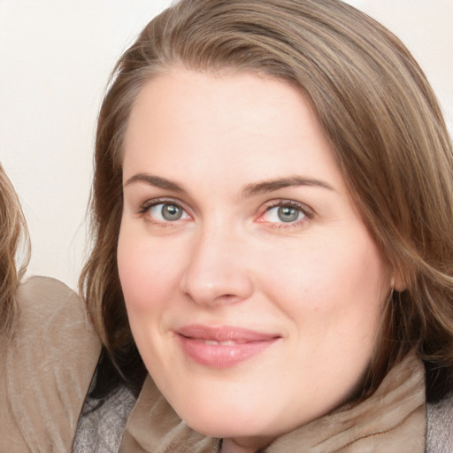 Joyful white young-adult female with medium  brown hair and blue eyes