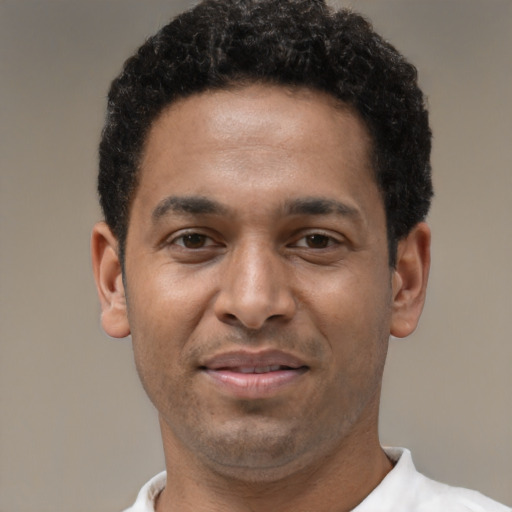 Joyful latino adult male with short  black hair and brown eyes