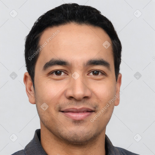 Joyful latino young-adult male with short  black hair and brown eyes