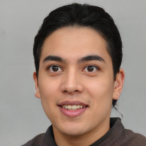 Joyful asian young-adult male with short  brown hair and brown eyes