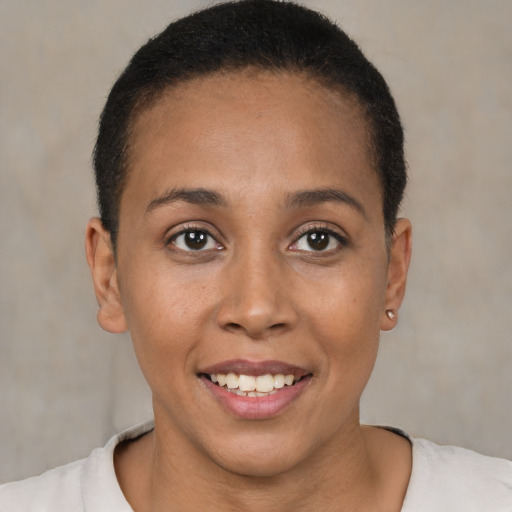 Joyful latino young-adult female with short  brown hair and brown eyes