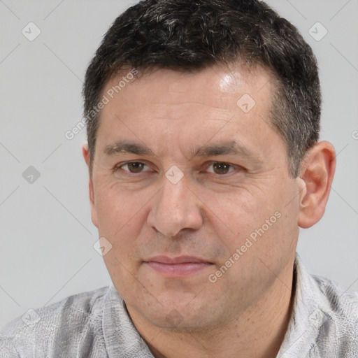 Joyful white adult male with short  black hair and brown eyes