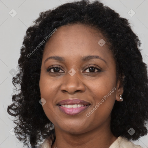 Joyful black young-adult female with long  brown hair and brown eyes