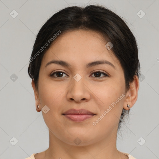 Joyful latino young-adult female with medium  brown hair and brown eyes