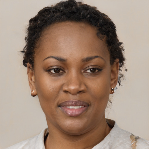 Joyful black adult female with short  brown hair and brown eyes