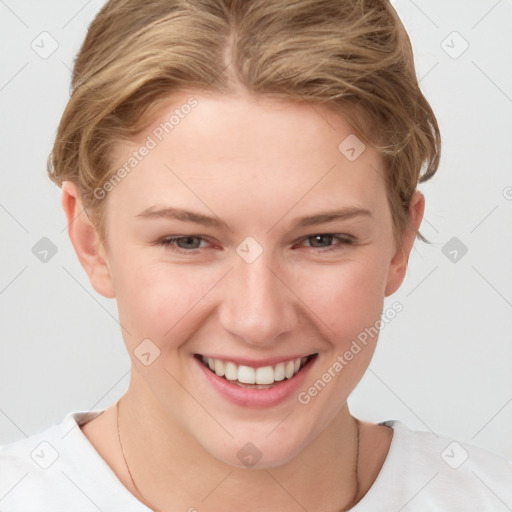 Joyful white young-adult female with short  brown hair and blue eyes