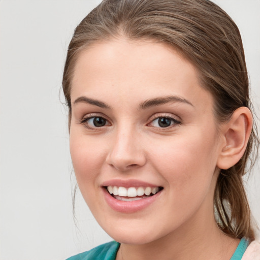 Joyful white young-adult female with medium  brown hair and blue eyes