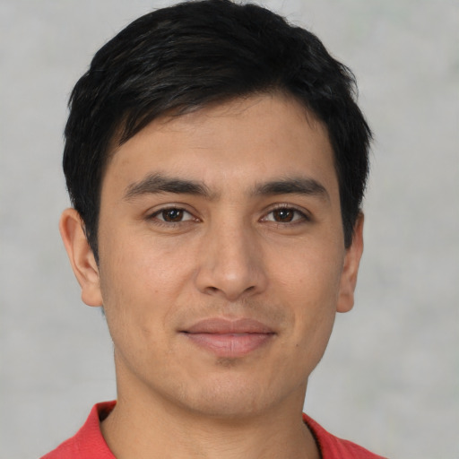 Joyful asian young-adult male with short  brown hair and brown eyes