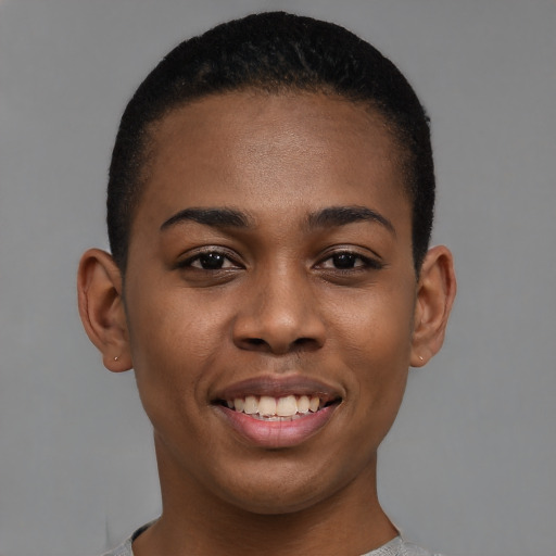 Joyful black young-adult female with short  black hair and brown eyes