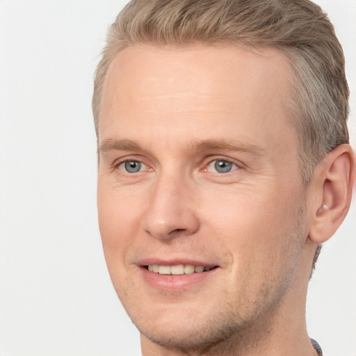 Joyful white adult male with short  brown hair and brown eyes