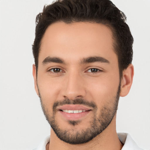 Joyful white young-adult male with short  black hair and brown eyes