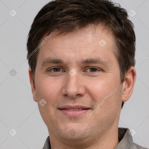 Joyful white adult male with short  brown hair and grey eyes