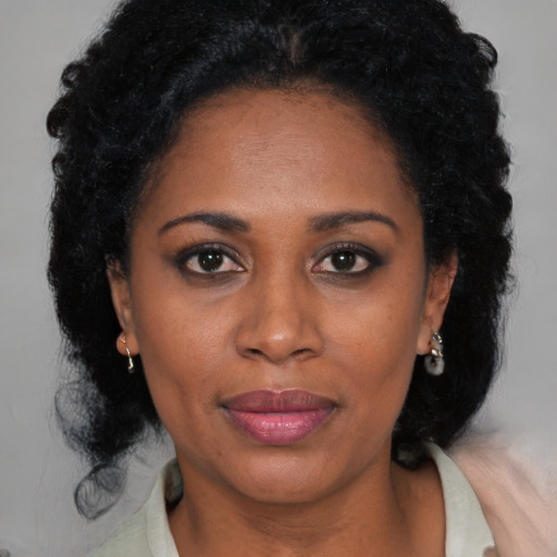 Joyful black adult female with medium  black hair and brown eyes