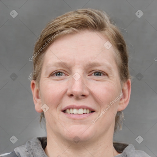 Joyful white adult female with medium  brown hair and blue eyes