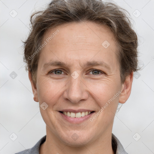 Joyful white adult male with short  brown hair and grey eyes