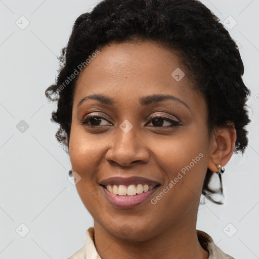 Joyful black young-adult female with long  brown hair and brown eyes