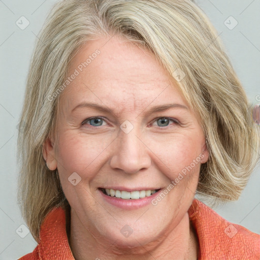 Joyful white adult female with medium  brown hair and blue eyes