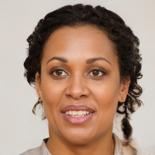 Joyful black young-adult female with medium  brown hair and brown eyes