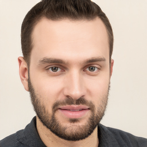 Joyful white young-adult male with short  brown hair and brown eyes