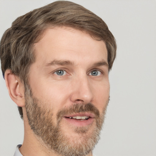 Joyful white adult male with short  brown hair and grey eyes