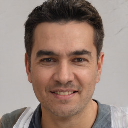 Joyful white adult male with short  brown hair and brown eyes