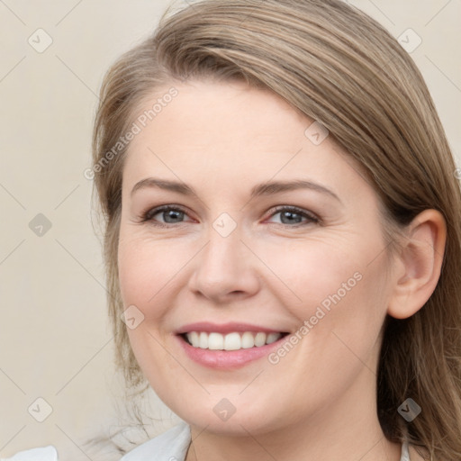 Joyful white young-adult female with medium  brown hair and grey eyes