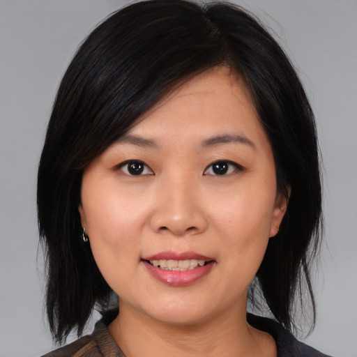 Joyful asian young-adult female with medium  black hair and brown eyes