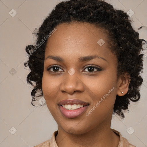 Joyful black young-adult female with long  brown hair and brown eyes