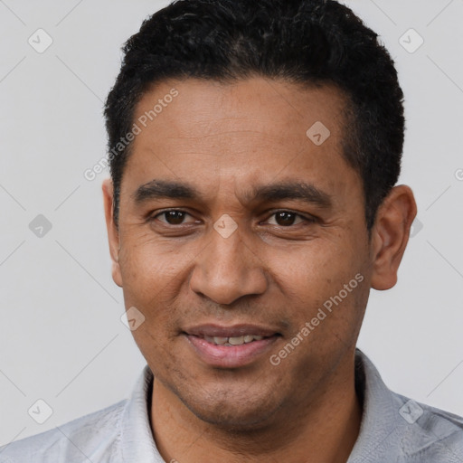 Joyful latino adult male with short  black hair and brown eyes