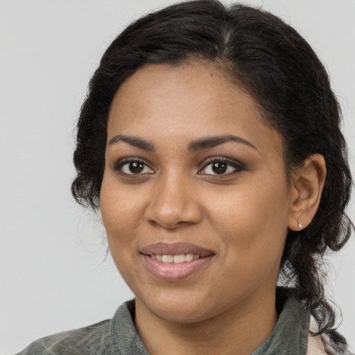Joyful black young-adult female with medium  brown hair and brown eyes