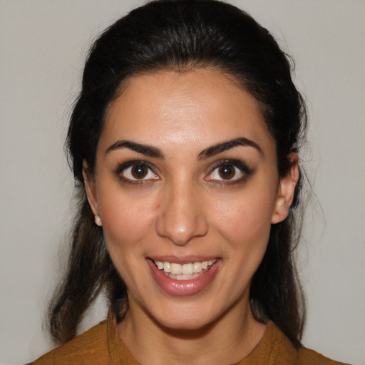 Joyful latino young-adult female with medium  brown hair and brown eyes