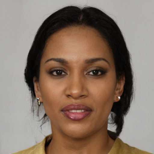 Joyful black young-adult female with medium  brown hair and brown eyes