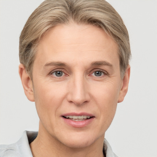 Joyful white adult female with short  brown hair and grey eyes