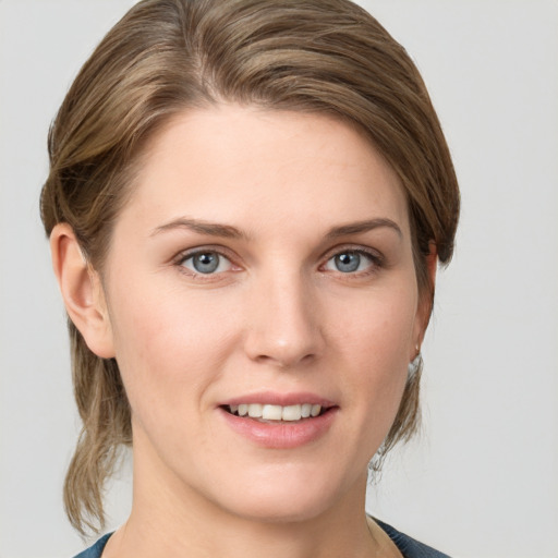 Joyful white young-adult female with medium  brown hair and grey eyes