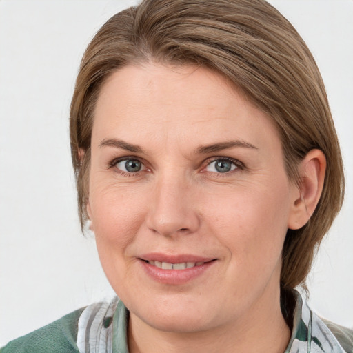 Joyful white adult female with medium  brown hair and blue eyes