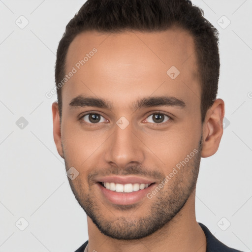 Joyful white young-adult male with short  brown hair and brown eyes