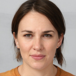 Joyful white adult female with medium  brown hair and brown eyes