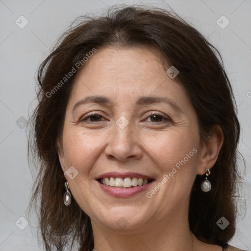 Joyful white adult female with medium  brown hair and grey eyes