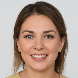 Joyful white young-adult female with medium  brown hair and brown eyes