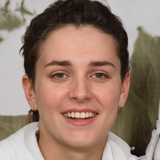 Joyful white young-adult female with short  brown hair and blue eyes