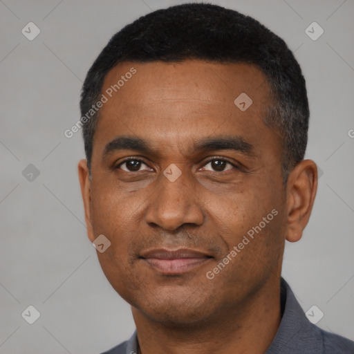 Joyful black young-adult male with short  black hair and brown eyes