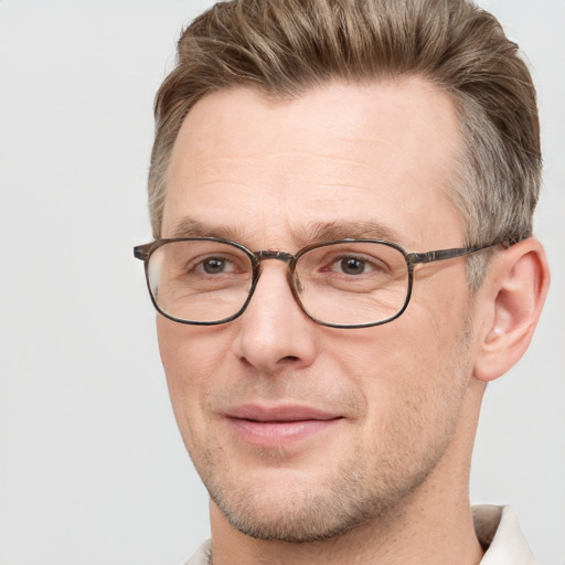 Joyful white adult male with short  brown hair and grey eyes