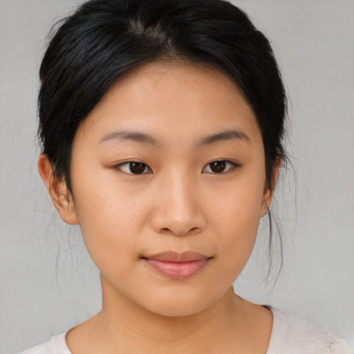 Joyful asian young-adult female with medium  brown hair and brown eyes