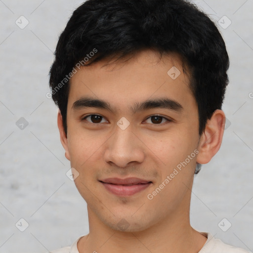 Joyful asian young-adult male with short  black hair and brown eyes