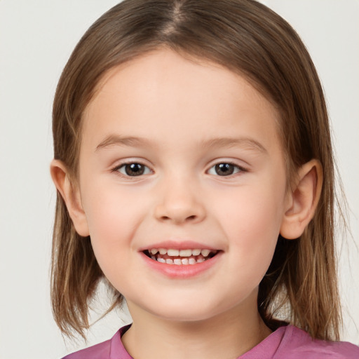 Joyful white child female with medium  brown hair and brown eyes