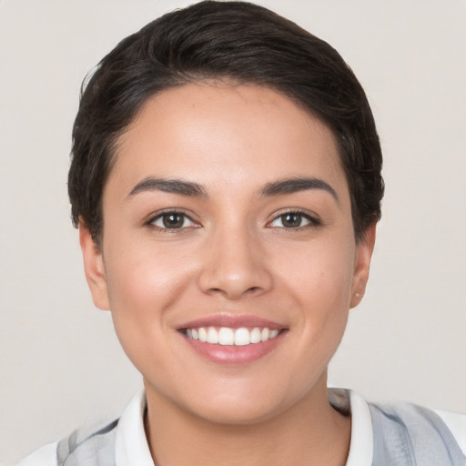 Joyful white young-adult female with short  brown hair and brown eyes