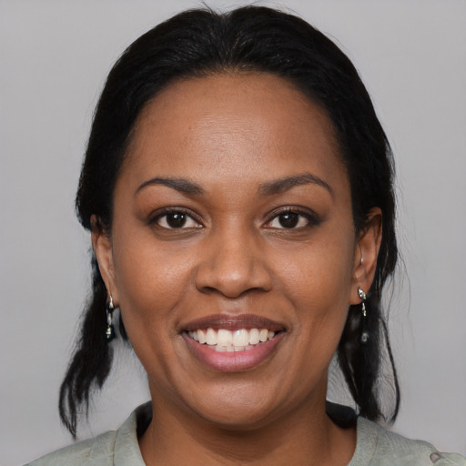 Joyful black adult female with medium  black hair and brown eyes