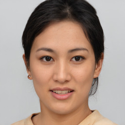 Joyful asian young-adult female with medium  brown hair and brown eyes